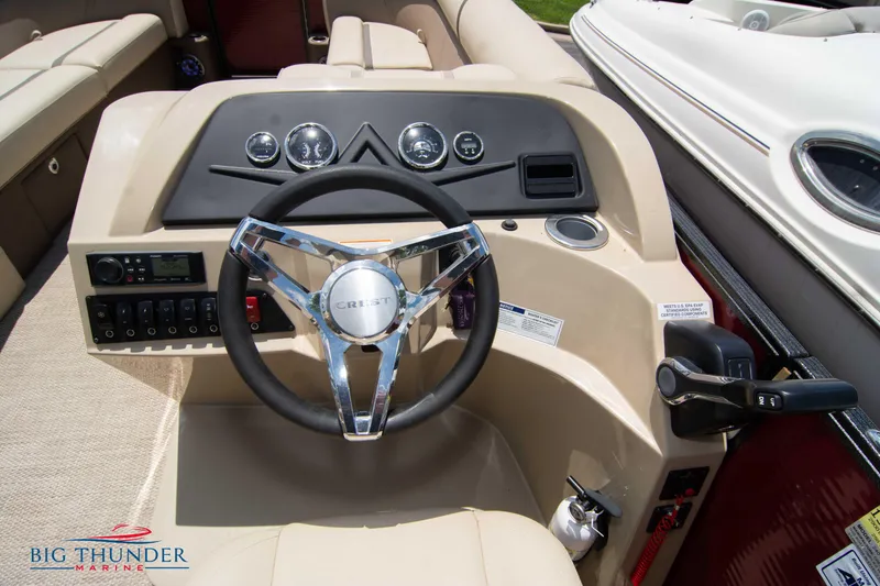 Slide: The Image of 2023 Crest CLASSIC LX 240 SLC boat steering console with chrome wheel and control panel. - 15
