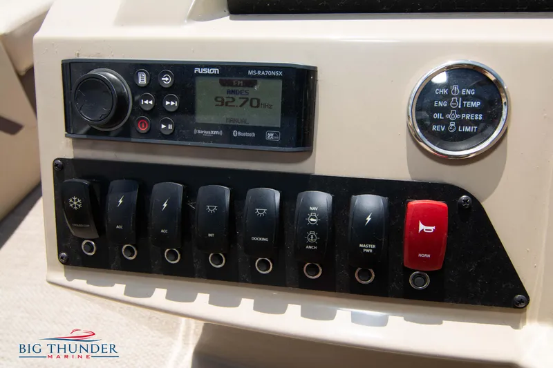 Slide: The Image of Control panel of a 2023 Crest CLASSIC LX 240 SLC boat with radio and switches. - 19