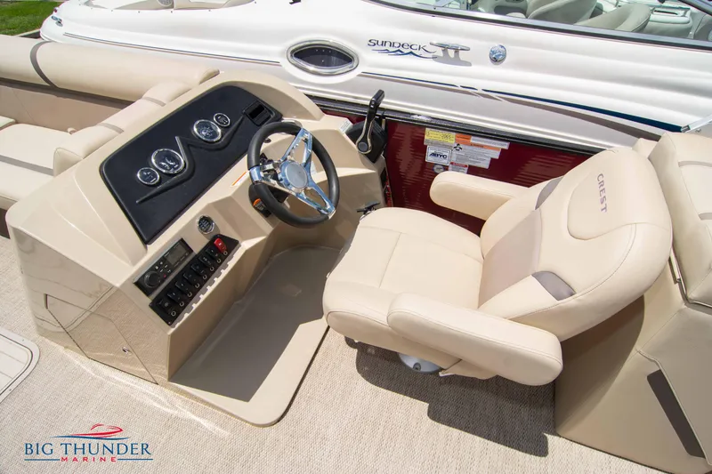Slide: The Image of 2023 Crest CLASSIC LX 240 SLC boat interior with steering console and captain's chair. - 21