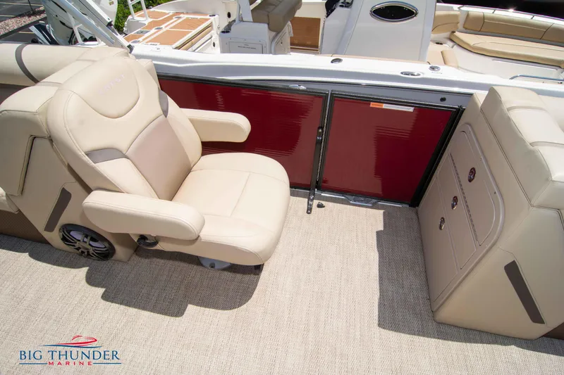 Slide: The Image of 2023 Crest CLASSIC LX 240 SLC boat interior with beige seating and red paneling. - 22