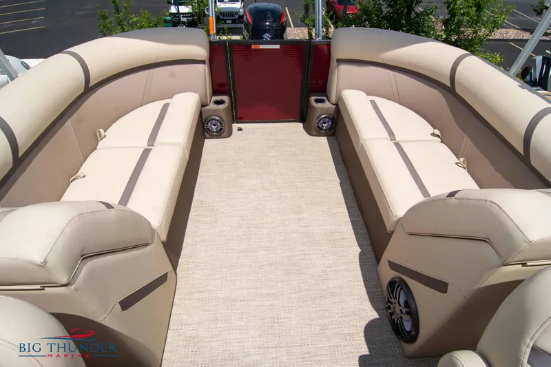 Slide: The Image of 2023 Crest CLASSIC LX 240 SLC pontoon boat interior with beige seating and carpet. - 24