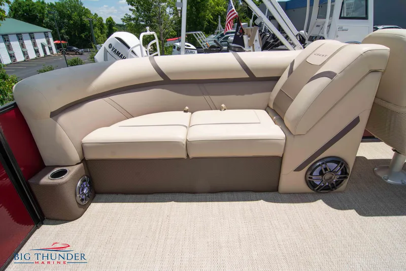 Slide: The Image of 2023 Crest CLASSIC LX 240 SLC boat interior with beige seating and speaker system. - 25