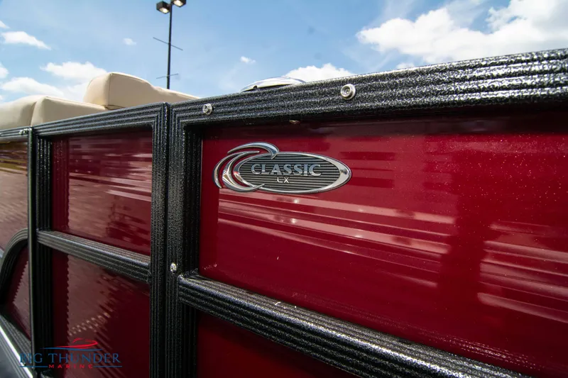 Slide: The Image of 2023 Crest CLASSIC LX 240 SLC pontoon boat, close-up of logo on red exterior. - 5