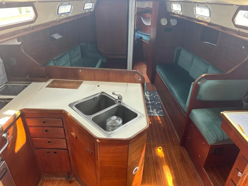 Slide: The Image of Interior of 1987 Sabre 42 sailboat with wood finish and compact kitchen area. - 11