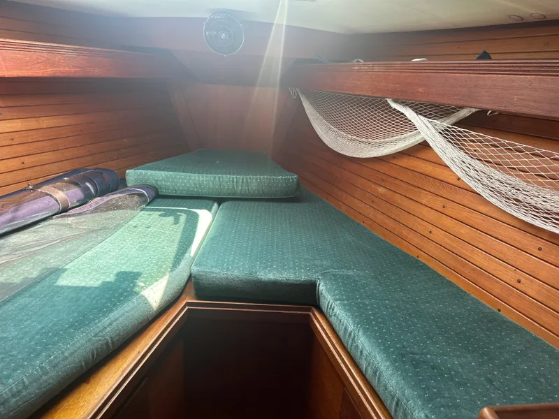 Slide: The Image of Interior cabin of 1987 Sabre 42 sailboat with green cushions and wooden paneling. - 12