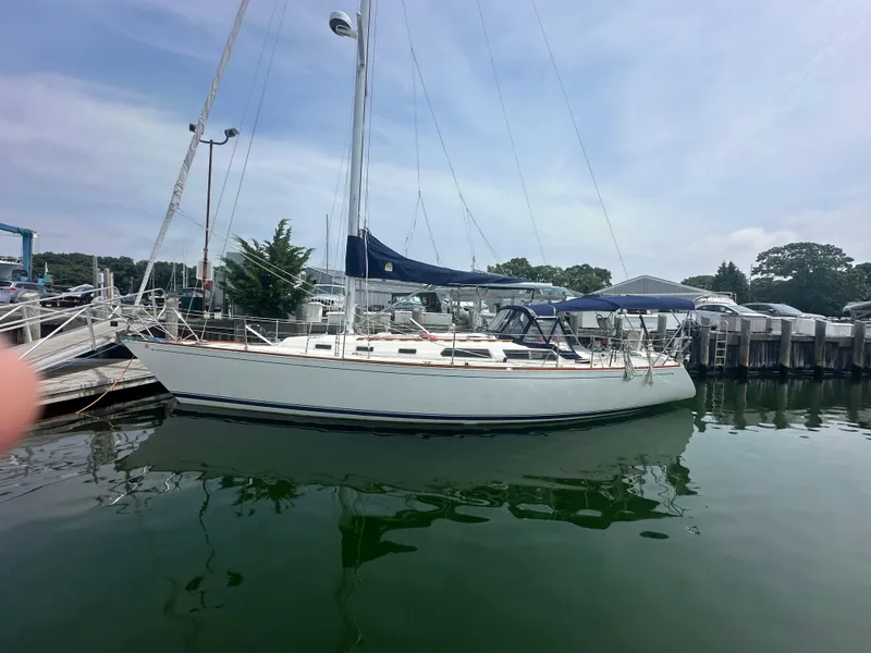 Slide: The Image of 1987 Sabre 42 sailboat docked in a marina, calm water, clear sky. - 3