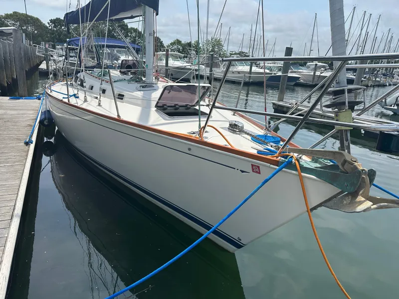 Slide: The Image of 1987 Sabre 42 sailboat docked at marina, featuring sleek white hull and rigging. - 6