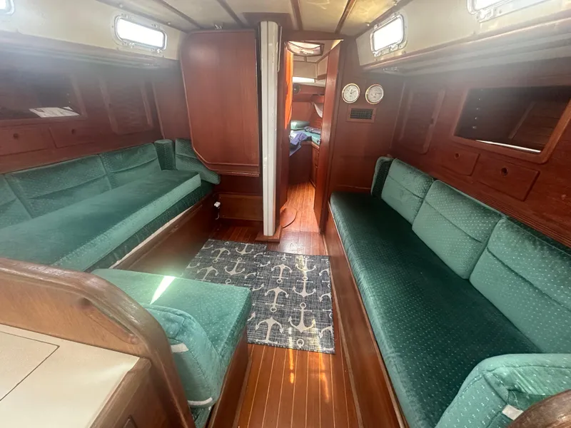 Slide: The Image of Interior of 1987 Sabre 42 sailboat with green seating and wooden finishes. - 8