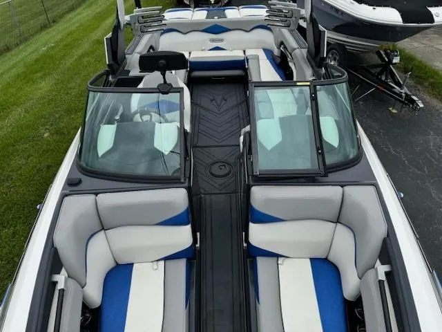 Slide: The Image of 2018 Supra SE boat interior with blue and white seating, windshield, and open deck. - 3