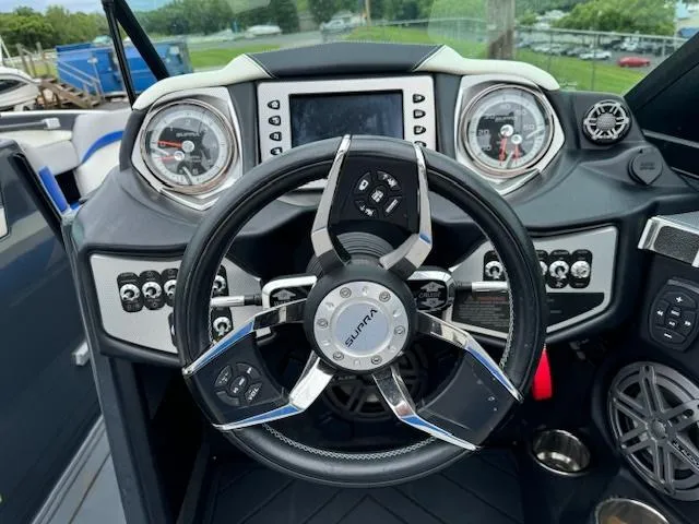 Slide: The Image of 2018 Supra SE boat dashboard with steering wheel and control panel. - 5