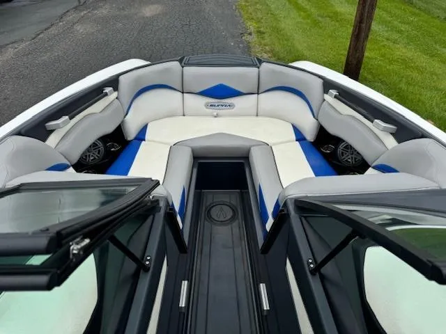 Slide: The Image of 2018 Supra SE boat with white and blue cushioned seating area. - 6