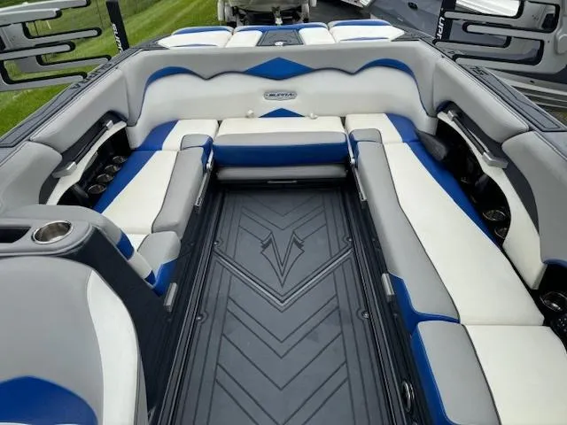 Slide: The Image of 2018 Supra SE boat interior with white, blue, and gray seating. - 7
