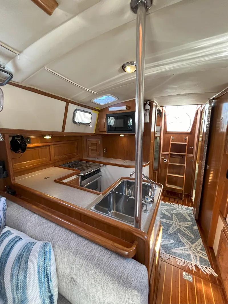 Slide: The Image of Interior of a 1998 Pacific Seacraft 40 yacht with kitchen and wood finish. - 23