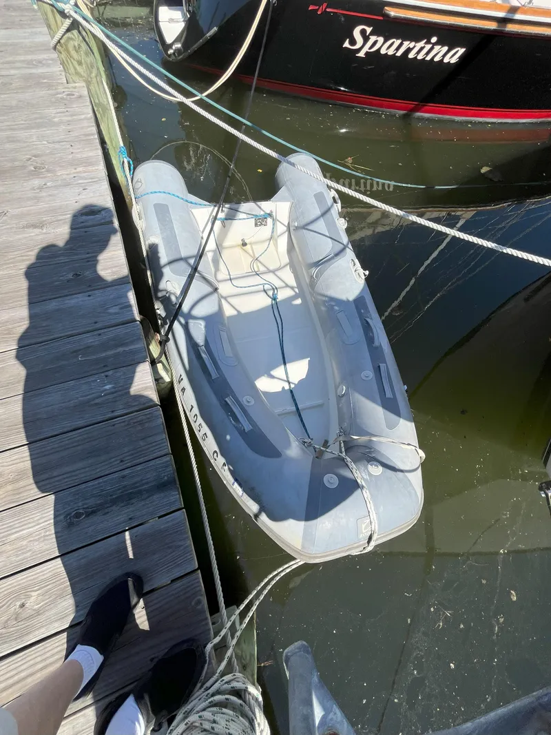 Slide: The Image of Inflatable boat beside a 1998 Pacific Seacraft 40 at the dock. - 47