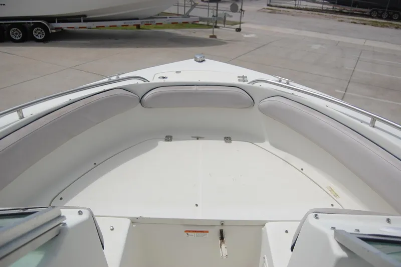 Slide: The Image of 2004 Hydra-Sports Lightning 202 DC boat bow seating area with white cushions. - 10