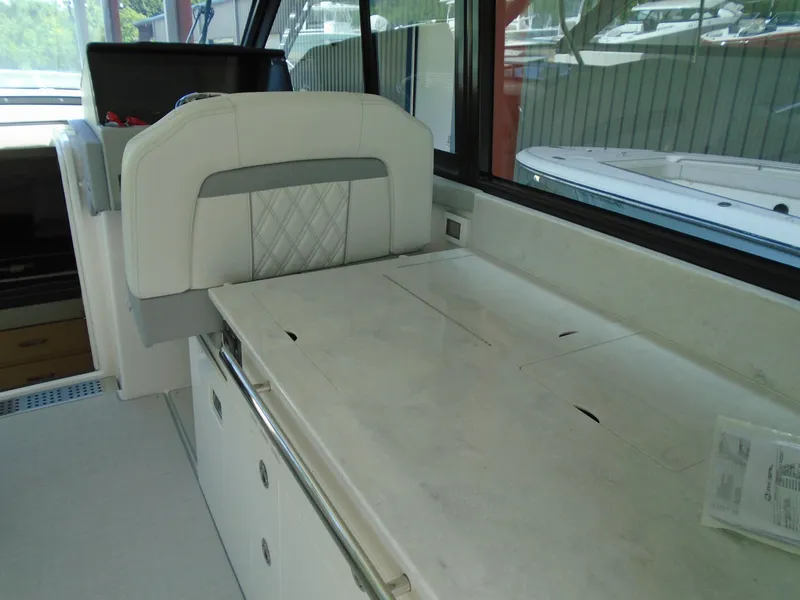 Slide: The Image of 2024 Regal 36XO yacht interior with white seating and countertop. - 11