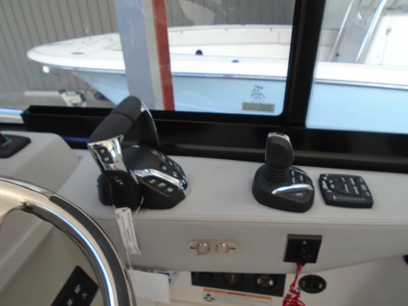 Slide: The Image of Control panel of a 2024 Regal 36XO boat with throttle and joystick. - 16
