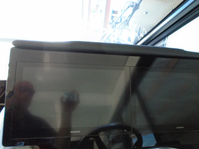 Slide: The Image of Dual Garmin displays on the 2024 Regal 36XO yacht dashboard. - 19