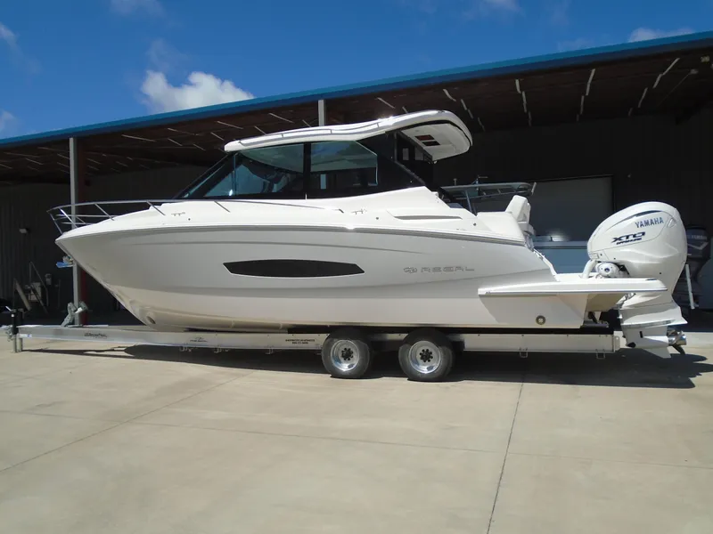 Slide: The Image of 2024 Regal 36XO boat on a trailer, side view. - 2