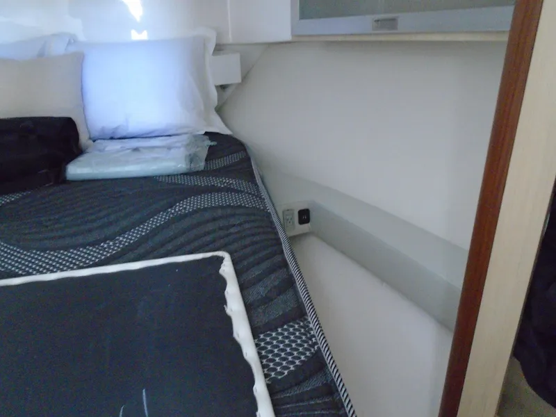 Slide: The Image of 2024 Regal 36XO yacht interior bedroom with bed and pillows. - 24