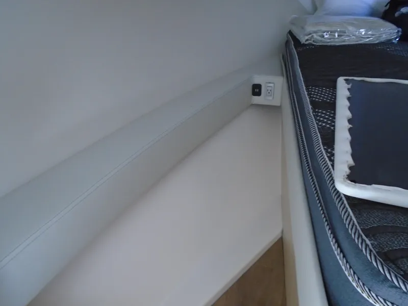 Slide: The Image of 2024 Regal 36XO interior cabin with bed and power outlet. - 25