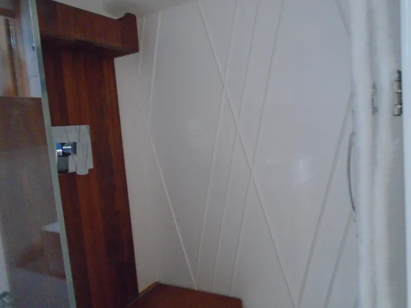 Slide: The Image of 2024 Regal 36XO yacht interior shower with modern design and wooden accents. - 27