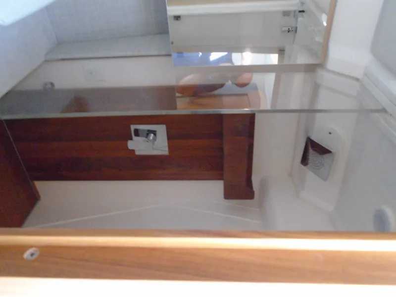 Slide: The Image of 2024 Regal 36XO yacht interior bathroom with wooden accents and modern fixtures. - 28