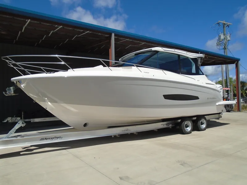 Slide: The Image of 2024 Regal 36XO boat on a trailer under a canopy. - 3