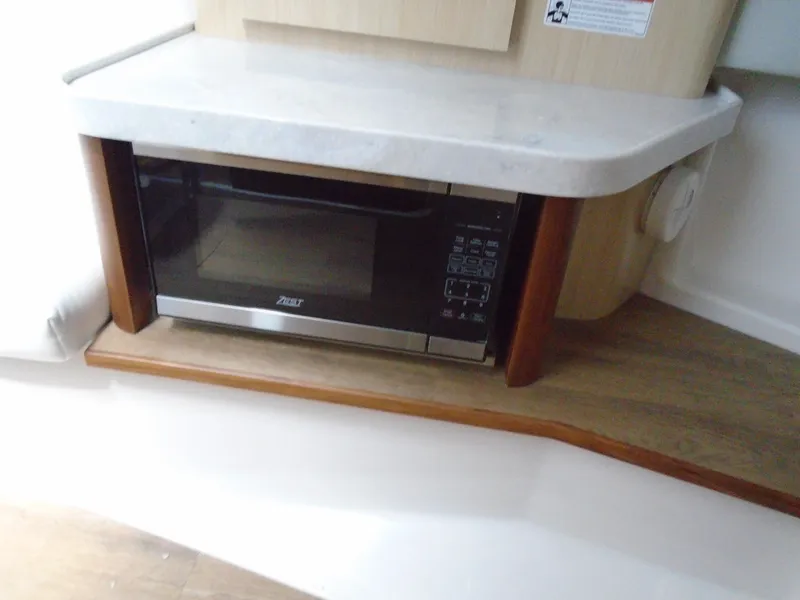 Slide: The Image of Built-in microwave in the 2024 Regal 36XO yacht kitchen. - 31