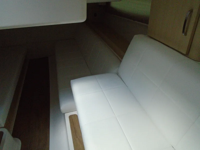 Slide: The Image of Interior seating area of 2024 Regal 36XO boat with white upholstery. - 32