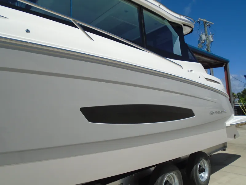 Slide: The Image of 2024 Regal 36XO boat side view on trailer. - 45