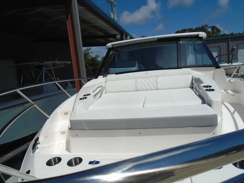 Slide: The Image of 2024 Regal 36XO luxury yacht with spacious deck and seating area. - 48