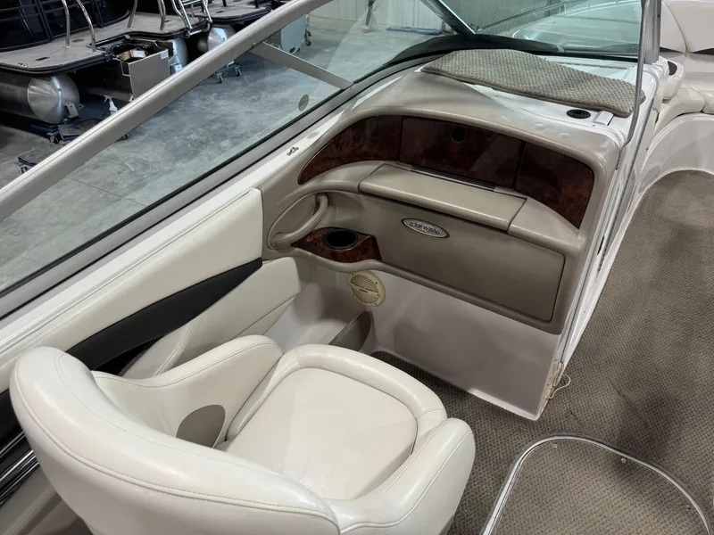 Slide: The Image of 2002 Four Winns 260 Horizon boat interior with white seating and wood accents. - 10