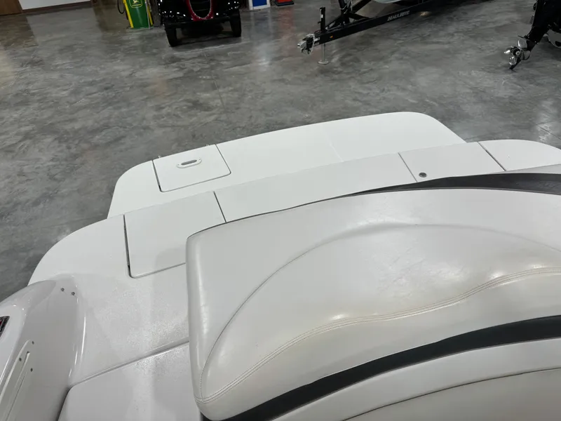 Slide: The Image of 2002 Four Winns 260 Horizon boat interior with white seating and storage compartments. - 11