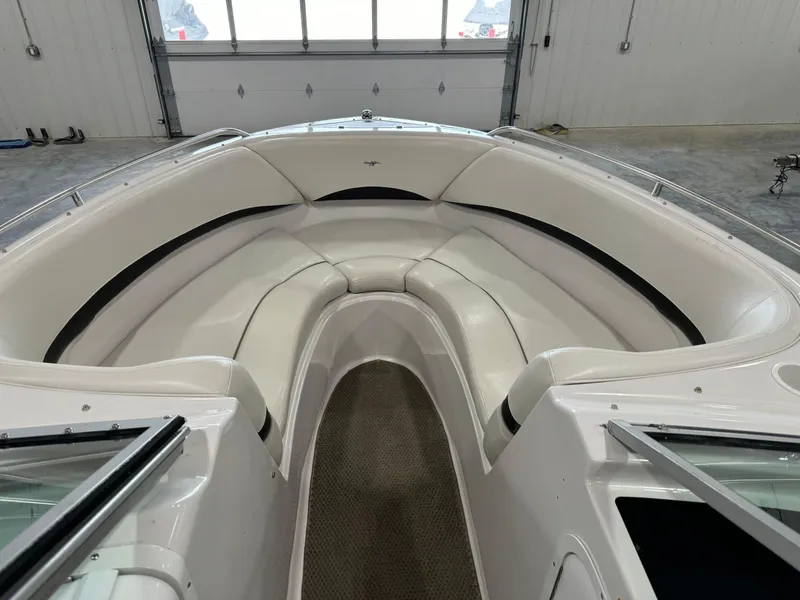 Slide: The Image of 2002 Four Winns 260 Horizon boat interior with white cushioned seating. - 5