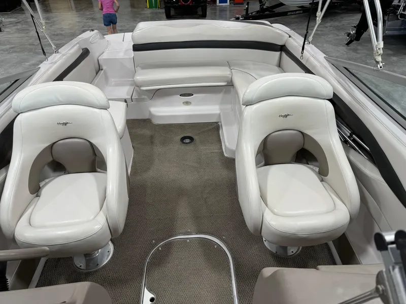 Slide: The Image of 2002 Four Winns 260 Horizon boat interior with white seating and carpeted floor. - 7