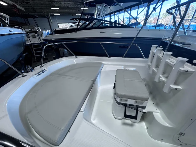 Slide: The Image of 2024 Boston Whaler 150 Montauk boat interior with seating and storage. - 2