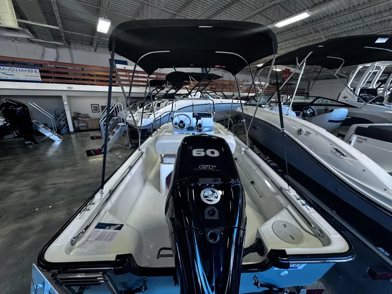 Slide: The Image of 2024 Boston Whaler 150 Montauk boat with 60 HP engine in showroom. - 5
