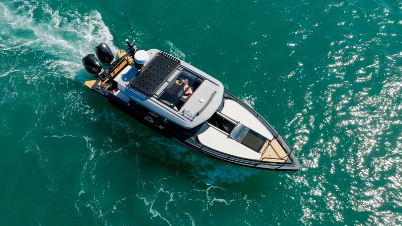 Slide: The Image of Aerial view of 2025 Arksen 30 boat cruising on clear blue water. - 11