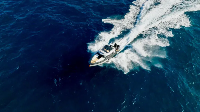 Slide: The Image of Aerial view of 2025 Arksen 30 boat speeding on open blue ocean. - 19