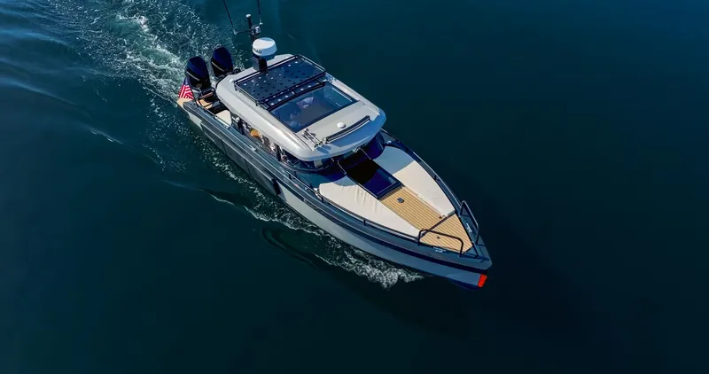 Slide: The Image of Aerial view of 2025 Arksen 30 boat cruising on calm water. - 22