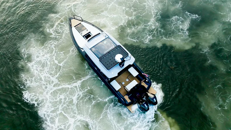 Slide: The Image of Aerial view of 2025 Arksen 30 boat cruising on water. - 23
