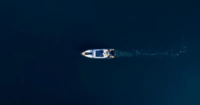 Slide: The Image of Aerial view of 2025 Arksen 30 boat cruising on dark blue water. - 25