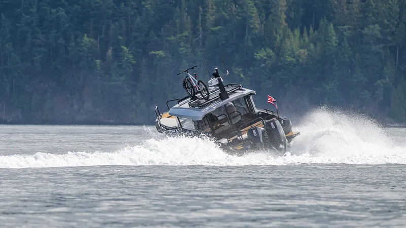 Slide: The Image of Arksen 30 boat cruising on water with forested background, 2025 model. - 27
