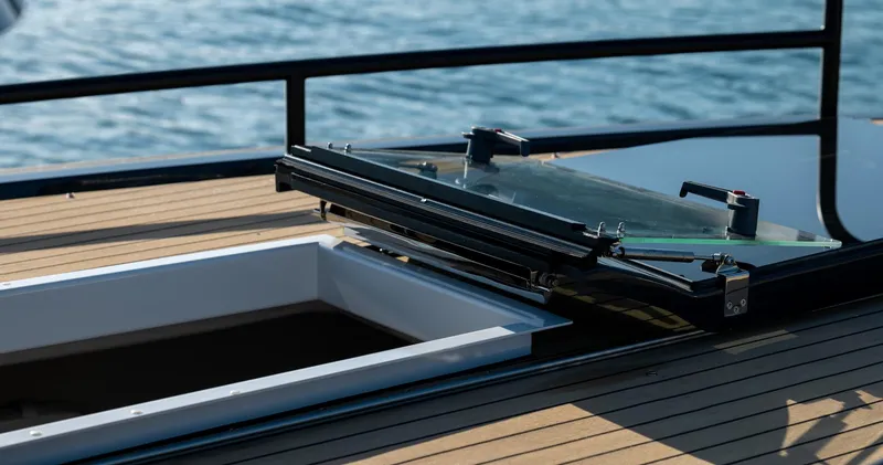 Slide: The Image of Open hatch on Arksen 30 yacht deck, 2025 model, with ocean in background. - 31