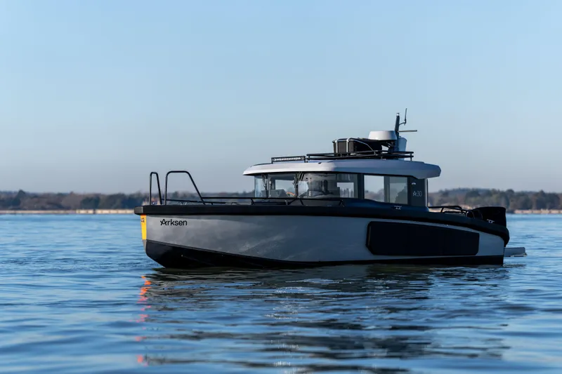 Slide: The Image of Arksen 30 boat on calm water, 2025 model, side view. - 5