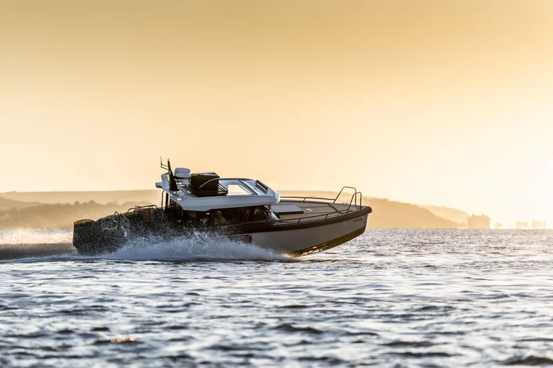 Slide: The Image of Arksen 30 boat cruising at sunset, 2025 model, on open water. - 6