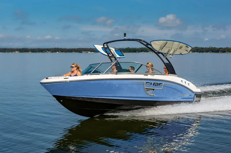 The Image of 2025 Chaparral 21 Surf boat cruising on a lake with passengers. - 0