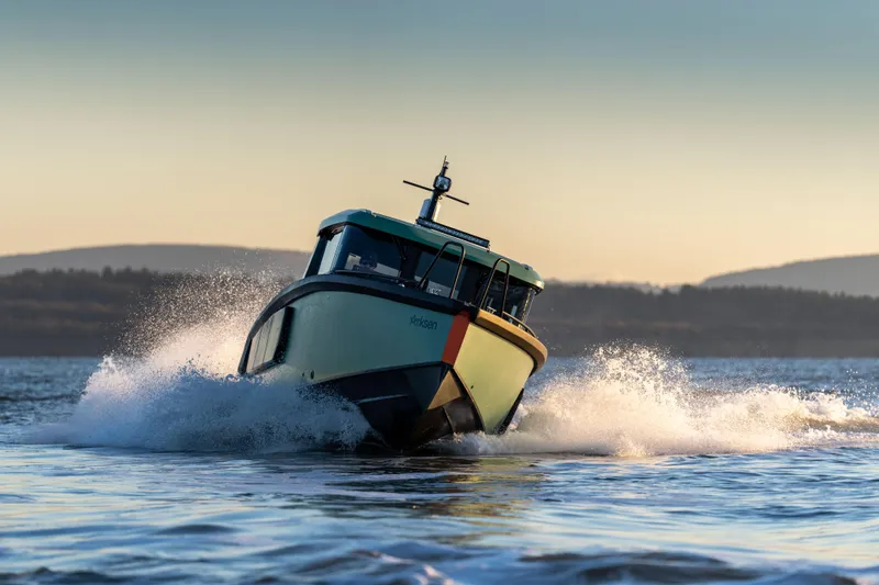 Slide: The Image of Arksen 28 boat cruising on water at sunset, 2025 model. - 1