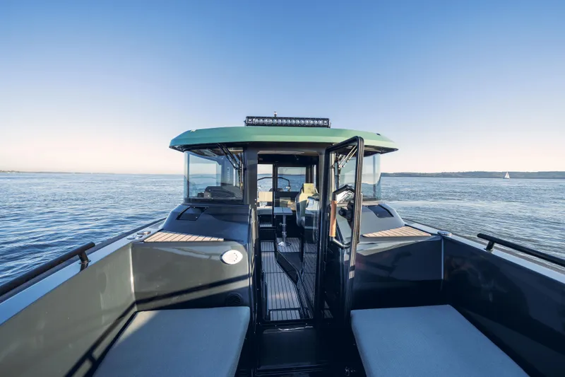 Slide: The Image of 2025 Arksen 28 boat on calm waters with clear blue sky. - 9